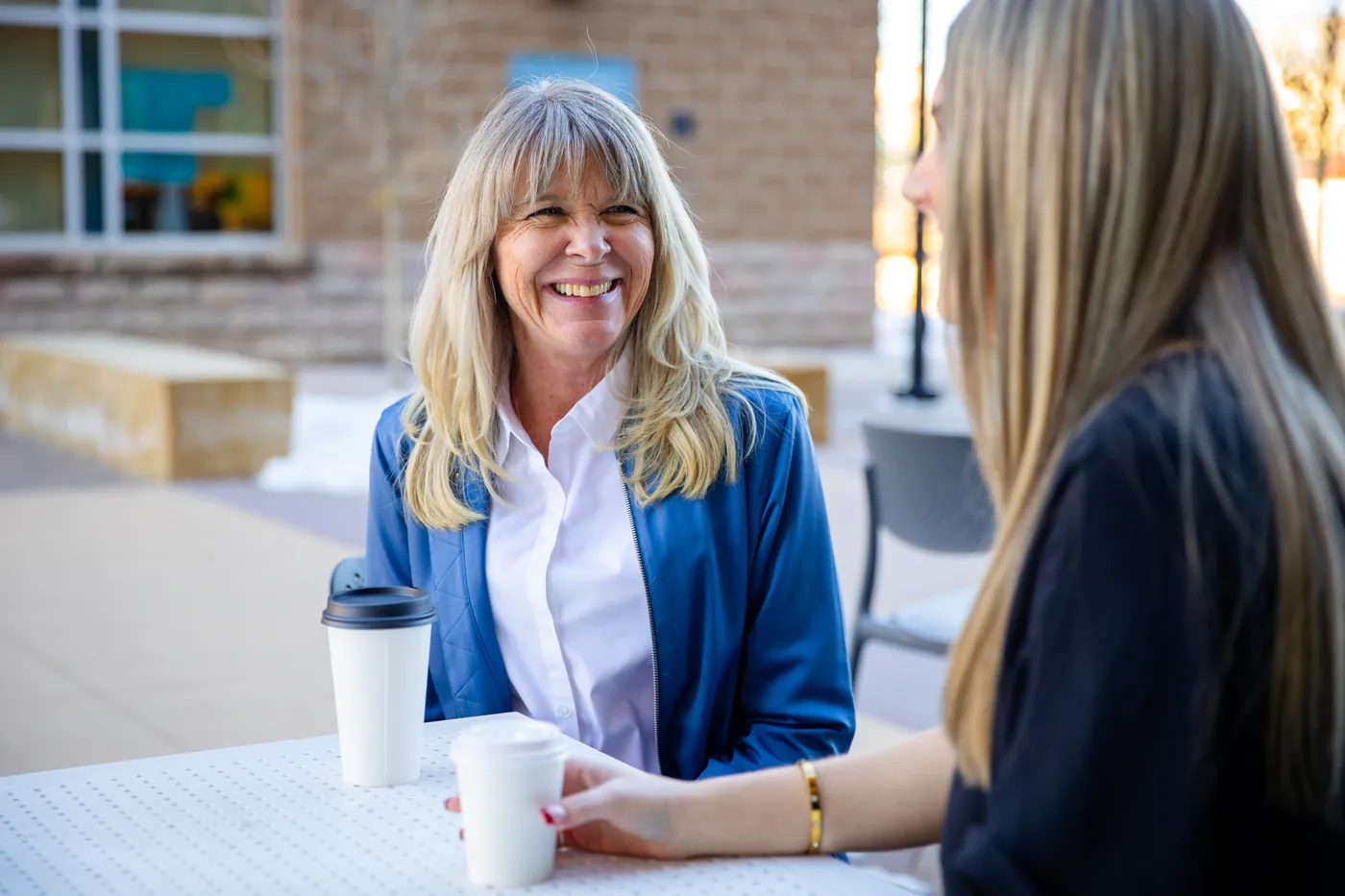 Stacey Dowling of DG Lending in conversation at an outdoor table, from our foundation shoot