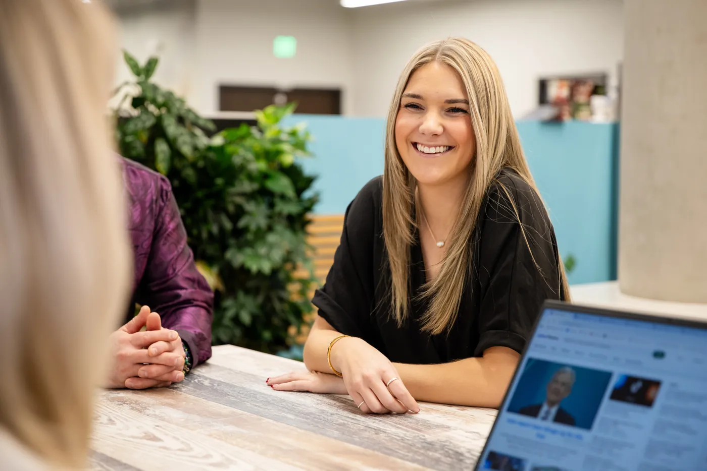 A DG Lending team member at her desk with a client